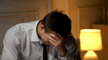 Ill businessman having strong headache, migraine problem, overworking lifestyle