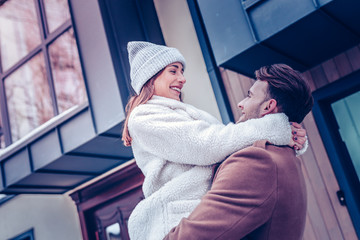 Girlfriend wearing warm winter hat feeling lovely with her man