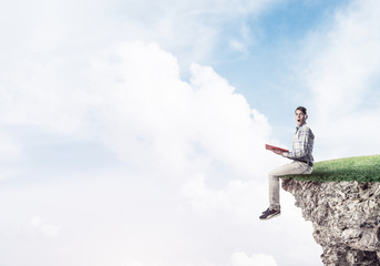 Student guy with book in hands preparing for exam