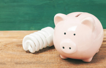Piggy bank on wooden table with copy space