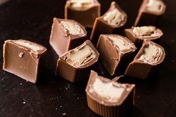 Tahini Filled Chocolate Pieces on Dark Wooden Surface / Tahin.