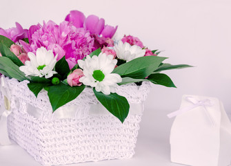 Bright beautiful bouquet of flowers with a gift box