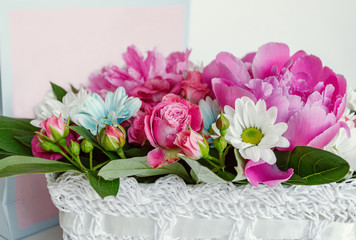 Bright beautiful bouquet of flowers with a gift box