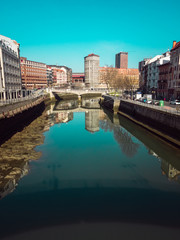 Fototapeta premium Puente de la Merced in Bilbao, reflections on the Ria de Bilbao on a sunny day