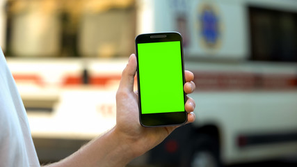 Patient holding phone, ambulance on background, site with online medical advices