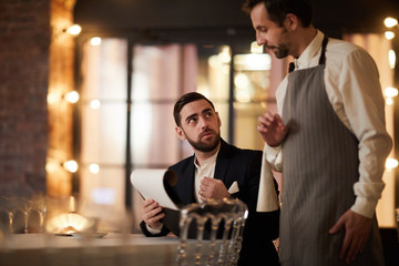 Portrait of handsome businessman ordering food in luxury restaurant