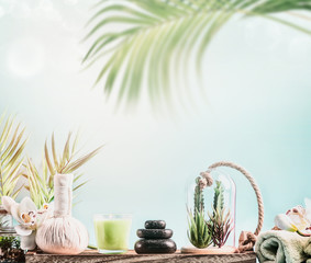 Tropical SPA background with wellness equipment, massage tools , towels and succulent plants at...