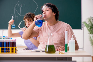 Two chemists students in classroom 