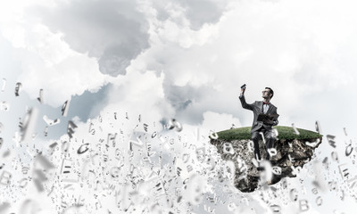 Young businessman or student studying the science and symbols fly around