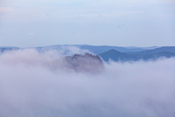 Fototapeta premium Low clouds hiding the Lion Island at Box Head, Sydney, Australia