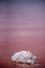 Macro View of the salt rock in red waved water of Salinas Torrevieja Spain Sunny day, selective focus