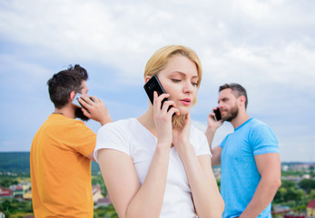 Meeting the need for communication. Modern people with smartphones outdoor. Group of friends...