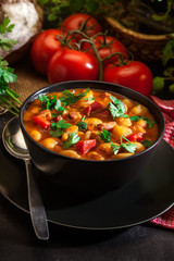 White bean soup with potatoes, tomatoes, paprika, and bacon