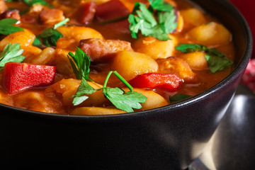 White bean soup with potatoes, tomatoes, paprika, and bacon