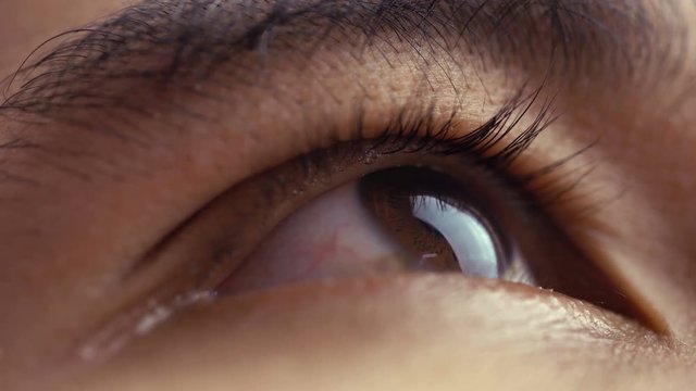 Close up of man's brown eyes looking upward