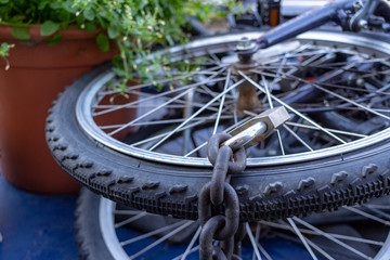 The bicycle wheels is locked with the iron rusty chain - Lost freedom and hope concept.