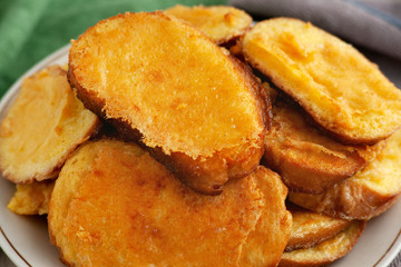 French toast with egg and cheese. Pieces of loaf fried in a mixture of eggs and cheese. French toast for breakfast. Golden appetizing crust from cheese.