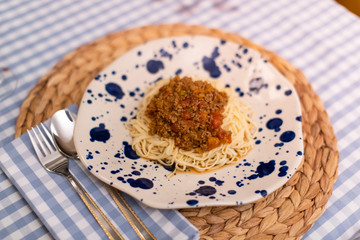 spaghetti bolognese served with wine