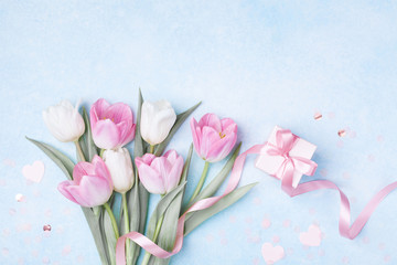 Women Day, Mother day background with gift box and beautiful spring tulip flowers on pastel blue...