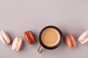 Morning cup of coffee and dessert macaron or macaroon top view. Flat lay.