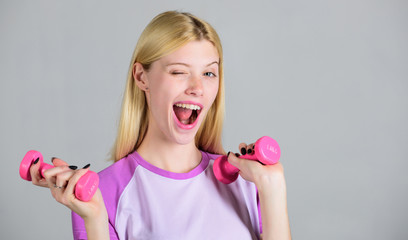 Healthy lifestyle concept. Woman adorable blonde exercising with dumbbell. Easy exercises with dumbbell. Workout with dumbbell. Girl hold dumbbell. Biceps exercises for female. Fitness instructor