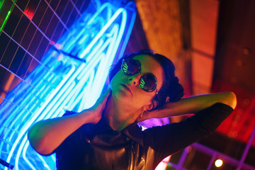 Cinematic night portrait of girl and neon lights