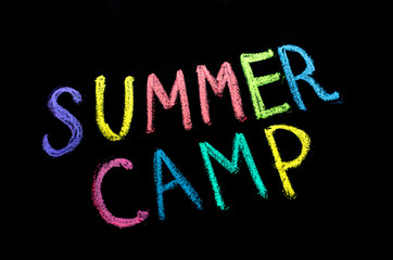 colored text summer camp on blackboard