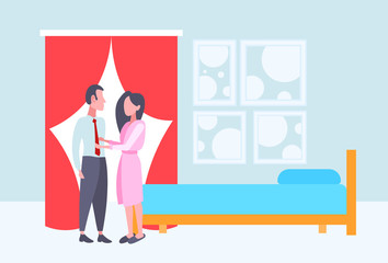 woman in bathrobe seeing off businessman in the morning before work happy couple lovers standing together modern bedroom interior full length flat horizontal