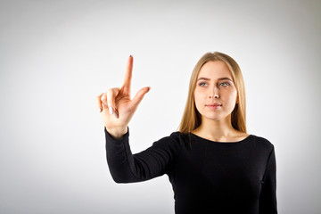 Young woman in black pushing the button