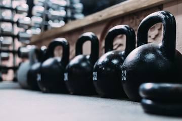 Kettlebells on 32 Kilograms stand in a row the first in focus