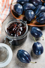 Plum jam in a can and plum.