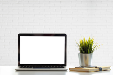 Mockup blank screen laptop on desk. Workspace with laptop and office supplies.