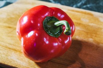 fresh red pepper on wooden cutting Board