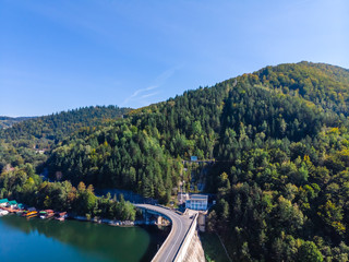 Aerial scenic view of a dam constructed on a beautiful valley in mountains. water storage...