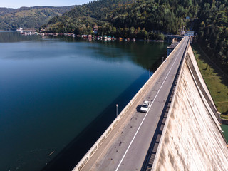 Aerial scenic view of a dam constructed on a beautiful valley in mountains. water storage...