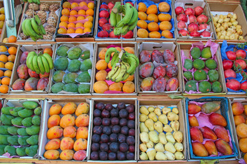 Fruit trays for sale of mangoes, pomegranates, bananas, plums, guava, oranges