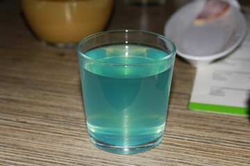 glass of water on blue background cocktail ,  smoothie ,  milkshake ,  mixed drink