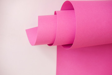 The bright pink sheet paper on a light pink paper sheet. Monochrome color paper design.