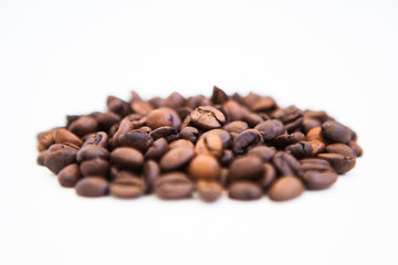 Coffee beans on a white ground, close up