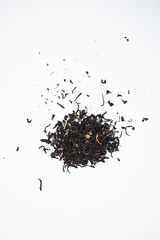 Black tea leaves on a white ground