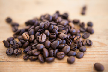Coffee beans on a wood ground