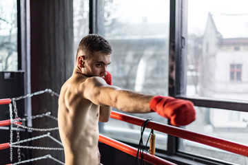Punhing man with red bandages in the ring