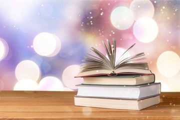 Old stacked books on wooden table