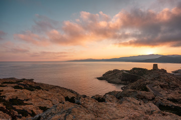 Sun rising over Genoese tower at Ile Rousse in Corsica