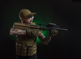 The guy in protective clothing and a black mask with a sniper rifle