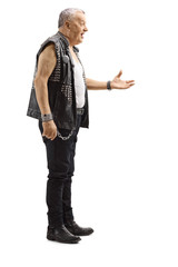 Mature male punker in a leather vest gesturing with hand