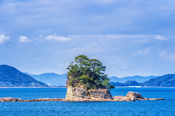 Many small islands over the blue ocean in sunny day, famous Kujukushima(99 islands) pearl sea...