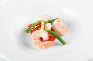 Serving Tom Yam Soup: Chef lays cherry tomatoes, king prawns, green beans and greens before serving soup