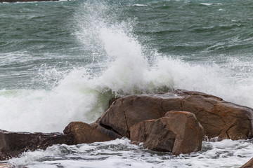ocean waves breaking into rocks and shore in stormy weather. stormy sea and great waves, a...