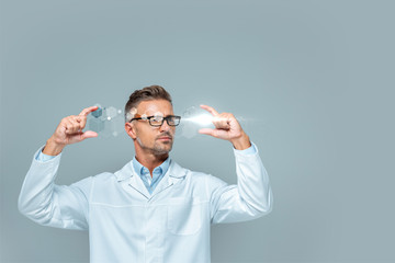 handsome scientist in glasses holding medical interface isolated on grey, artificial intelligence...